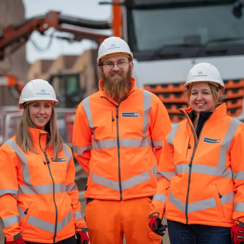 Group image of three YTL Construction employees wearing PPE