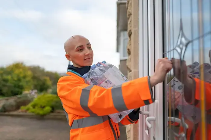 A Wessex Water employee delivering bottled water to a customer