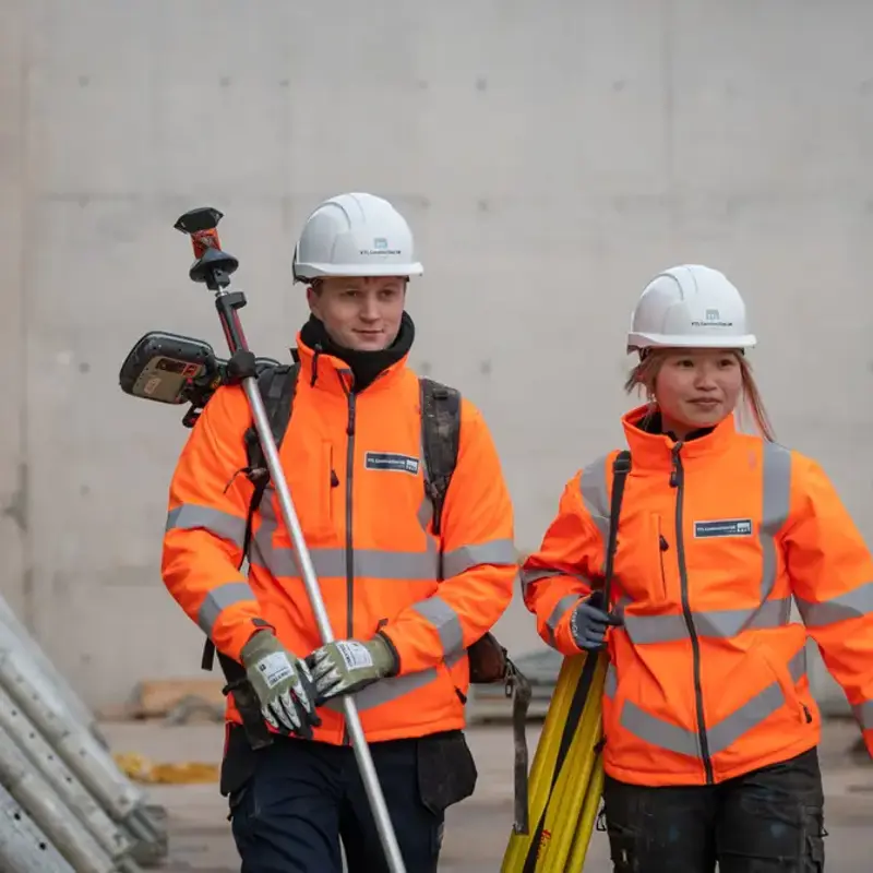 Two YTL construction team members in protective gear