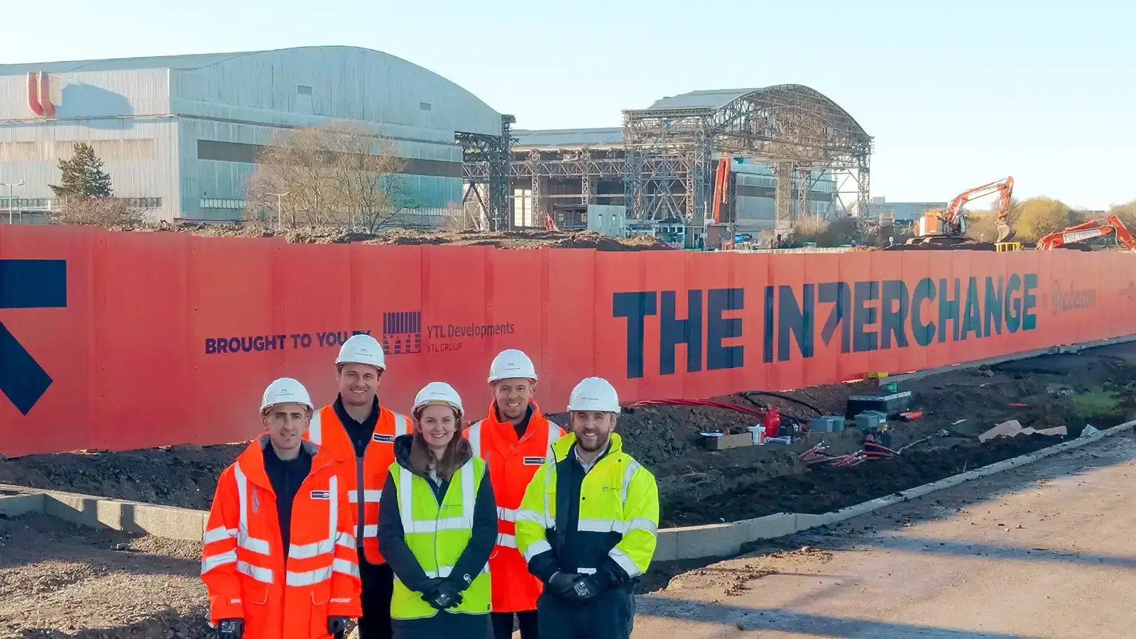 YTL team stood in front of the The Interchange office under construction